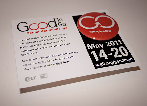 4 by 6 inch card promoting the Good to Go Commuter Challenge, with a 3 inch red button with white logo attached on the top right of the card.